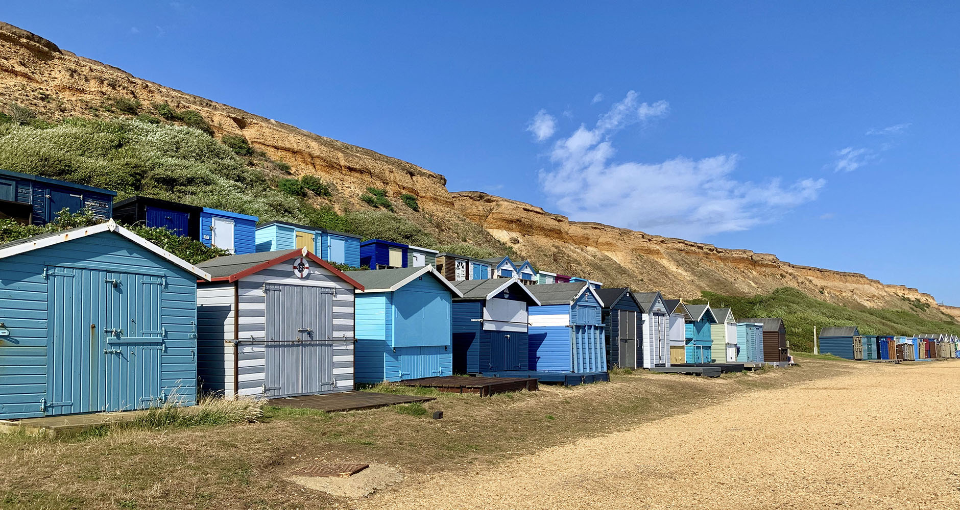 Bright coloured beach huts in Barton-on-Sea