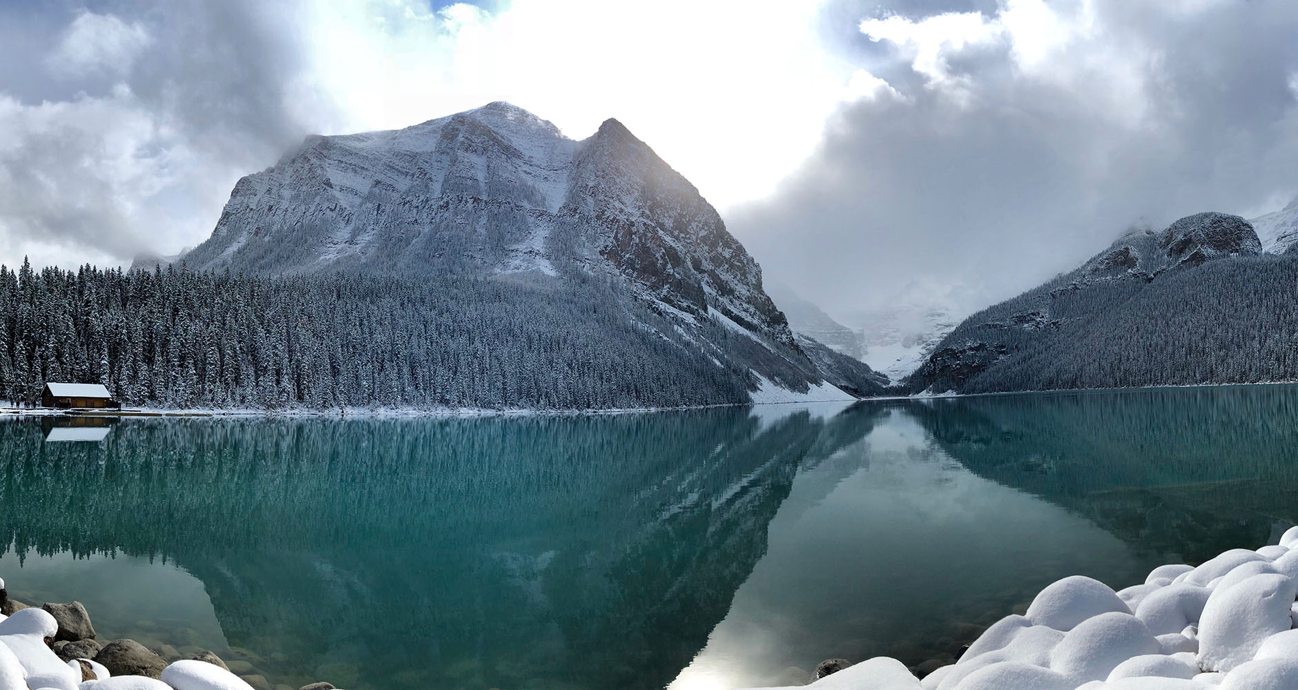 Lake Louise surrounded by snowy trees in Banff - Alberta, Canada