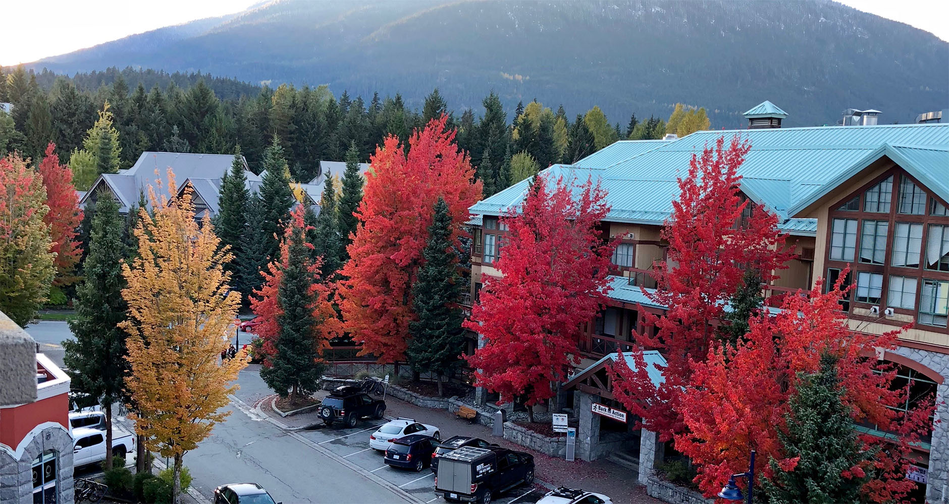 The view from our balcony showing beautiful autumnal trees at Summit Lodge Boutique Hotel in Whistler, Canada